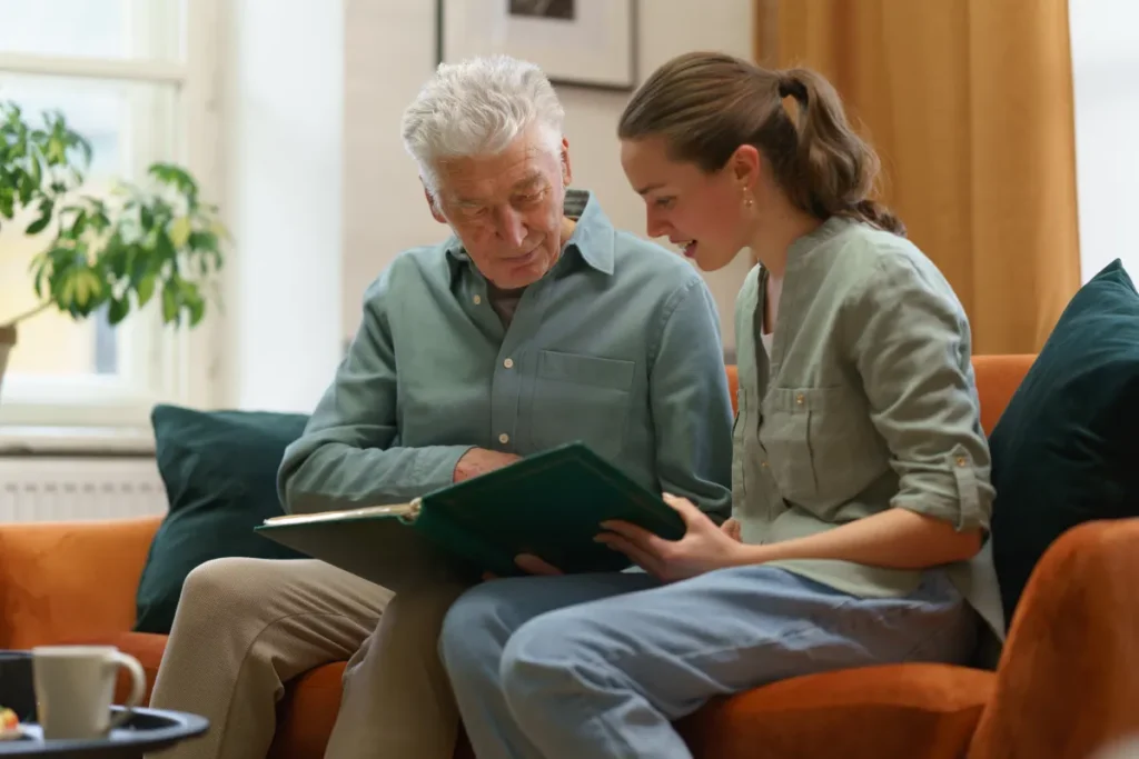 Senior man and relative looking at pictures
